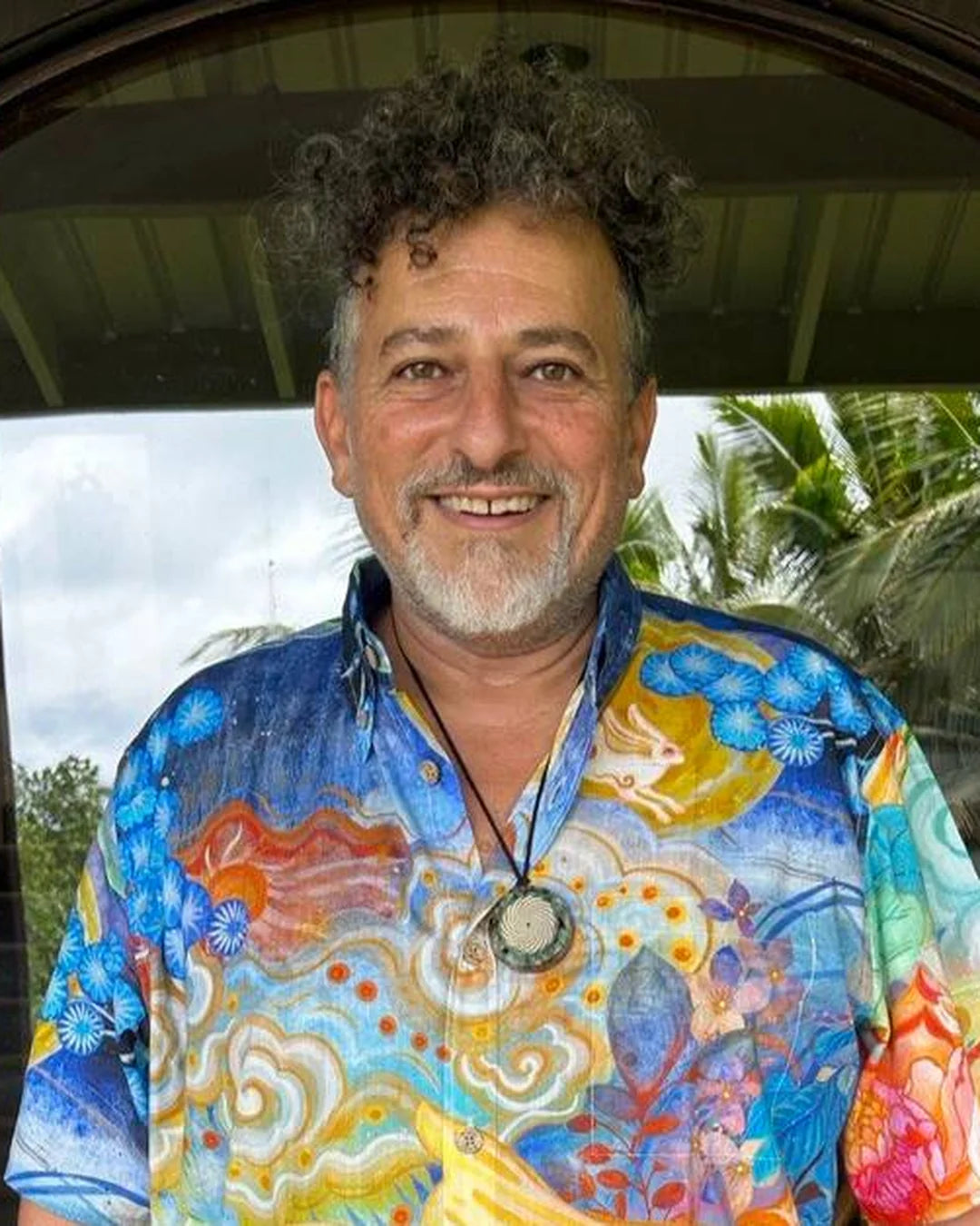 David Wolfe smiling outdoors in a colorful shirt